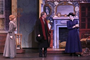 “Each virtue virtually knows no bound; each trait is great and patently sound!” (Brandi Burkhardt as “Mary Poppins” advises Shannon Warne as “Mrs. Banks” & Martin Kildare as “Mr. Banks” that she’s “Practically Perfect In Every Way”.)