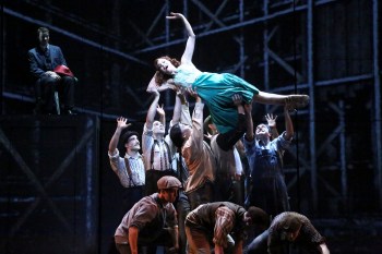 Kevin Earley as “Michael” looks on in admiration while Stephanie Gibson as “Frankie” works her own irrepressible charm on the “Empire State” building crew.