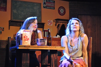 “Your life won’t always work out for the best—every trial’s not a test, nor each loss a lesson...” Maya Sayre as “Lisa” acquaints Tara Shoemaker as her pal “Waverly” with some uncomfortable truths including that “You Can’t Be Everything You Want” 
