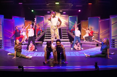 “Did they really get pinned? Did she kiss him and cry? Did he pin the pin on? Or was he too shy?” Kieara Williams as “Usula Merkle” spreads a tantalizing bit of news about BFF “Kim MacAfee” to all their pals during “The Telephone Hour” in One More Production’s “Bye Bye Birdie”