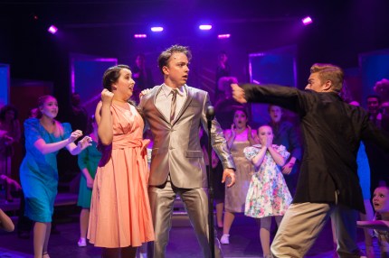 "Bye-bye Birdie! Its awful hard to bear; Bye-bye Birdie, guess we'll always care!" Megan Oviatt as "Kim" is shocked when Hayden Mangum as her 'steady' "Hugo" 'gives Zackary Martinez as "Conrad Birdie" his own unique style of greeting! 