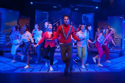 “Life's a ball--if only you know it! And it's all just waiting for you--you're alive, So come on and show it, we got a lot of livin’ to do!” Zack Martinez as “Conrad Birdie” joins Megan Oviatt as “Kim MacAfee” and friends for a night on the town in One More Production’s “Bye Bye Birdie” 