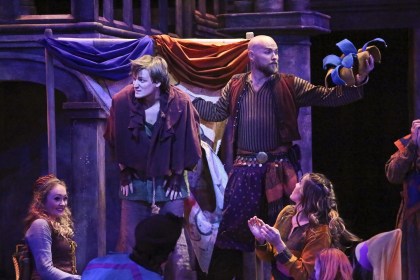 “Here it is! You know exactly what’s in store—now’s the time we laugh until our sides get sore. Now’s the time we crown the King Of Fools!” Keith A. Bearden as “Clopin” prepares to ‘honor’ John McGinty as “Quasimodo” on “Topsy-Turvy Day” while the company looks on in “The La Mirada Theatre For The Performing Arts” & “McCoy-Rigby Entertainment’s production of "The Hunchback Of Notre Dame”