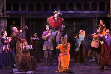 “Ladies and gentleman! We are in luck! We asked for the ugliest face in Paris, and we found him: Quasimodo--The Hunchback of Notre Dame!” “Quasimodo” (John McGinty center on shoulders) is mockingly ‘celebrated’ by the company in “The La Mirada Theatre For The Performing Arts” & McCoy-Rigby Entertainment’s production of "The Hunchback Of Notre Dame” 