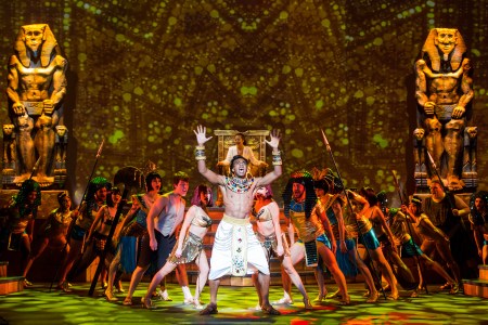 “Well this dream has got me baffled! Hey, Joseph, won't you tell me what it means? You know that kings ain't stupid but I don't have a clue! So don’t be cruel Joseph—Help me I beg of you!” Edred Utomi as “The Pharaoh Rameses I” asks Justin Anthony Long as “Joseph” to interpret his unsettling dreams in 3-D Theatrical’s “Joseph & The Amazing Technicolor Dreamcoat” 