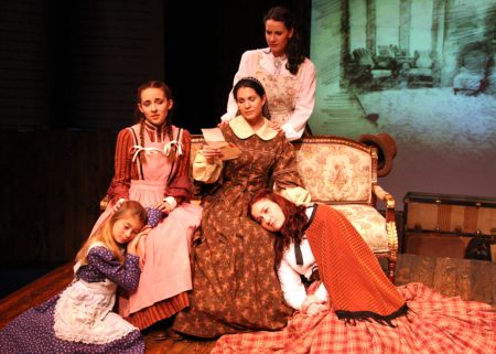 “Give them all my love, and give them a sweet kiss; tell them to be good girls, faithful and hard working, and to conquer that which is disagreeable in them, so that when I return I shall be fonder and prouder of my little women…” Rachel Oliveros Catalano as “Marmee”, reads a letter from their father to daughters Olivia Knox as “Young Amy’, Emma Nossal as “Beth”, Laura M. Hathaway as “Meg” and Ashley Arlene Nelson as “Jo” in The Chance Theater’s “Little Women—The Broadway Musical”